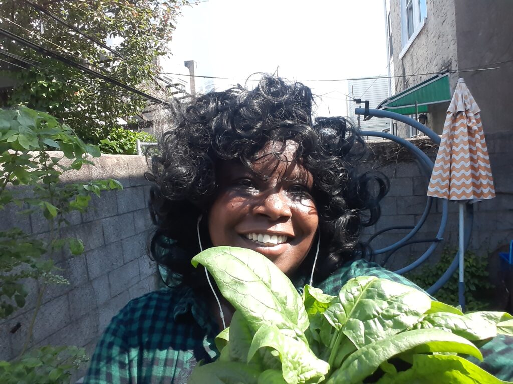 Website author holding spinach on a back patio in S Philadelphia.